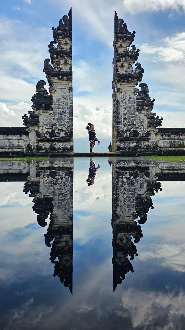 A Tripaway traveller reflected in the gates at Lempuyang Temple