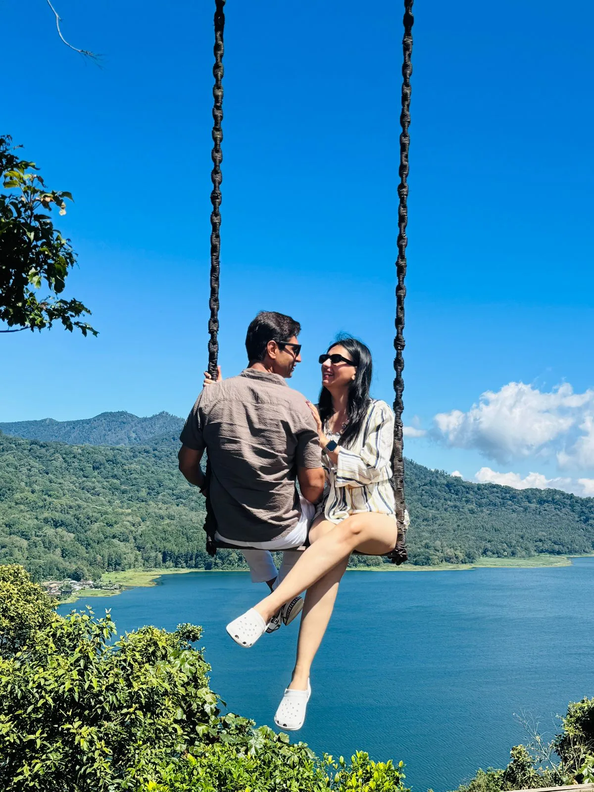 A Tripaway couple on a lakeside swing